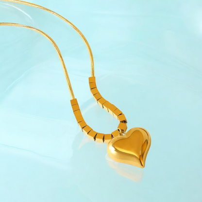 Elevate your style with Kaia, the gold-plated heart pendant necklace that's gym-proof and perfect for any occasion. Made with 18K gold plating, it's resistant to water, heat, and sweat, making it the perfect accessory for the bold risk-taker in you. Give it as a special gift for Valentine's Day, Mother's Day, or Christmas and embrace your gym-chic style with Kaia.
