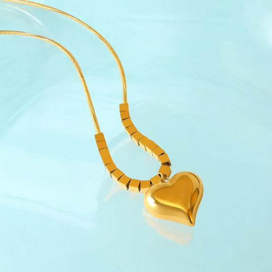 Elevate your style with Kaia, the gold-plated heart pendant necklace that's gym-proof and perfect for any occasion. Made with 18K gold plating, it's resistant to water, heat, and sweat, making it the perfect accessory for the bold risk-taker in you. Give it as a special gift for Valentine's Day, Mother's Day, or Christmas and embrace your gym-chic style with Kaia.
